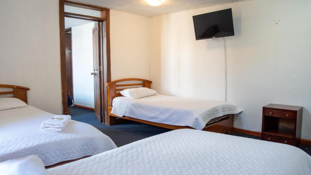 Postel nebo postele na pokoji v ubytování Hostal Barón de Carondelet