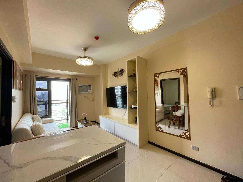 a large bathroom with a tub and a mirror at The Radiance Manila Bay in Sampong