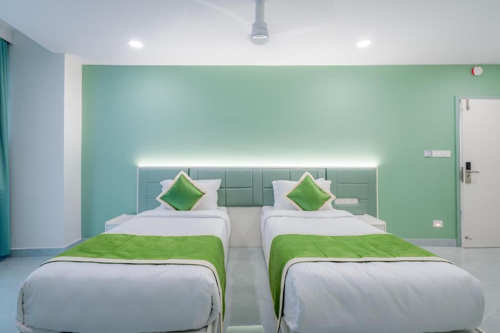 Postel nebo postele na pokoji v ubytování Grace Suites