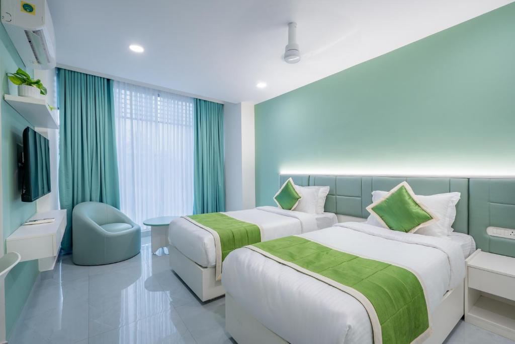 Postel nebo postele na pokoji v ubytování Grace Suites