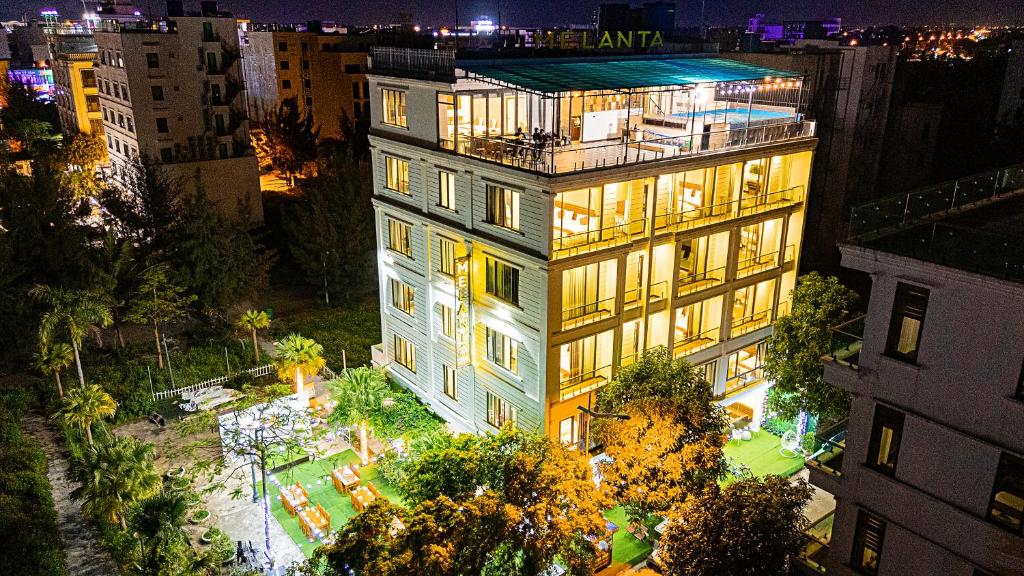 an aerial view of a building at night at MELANTA HOTEL FLC SẦM SƠN in Sầm Sơn