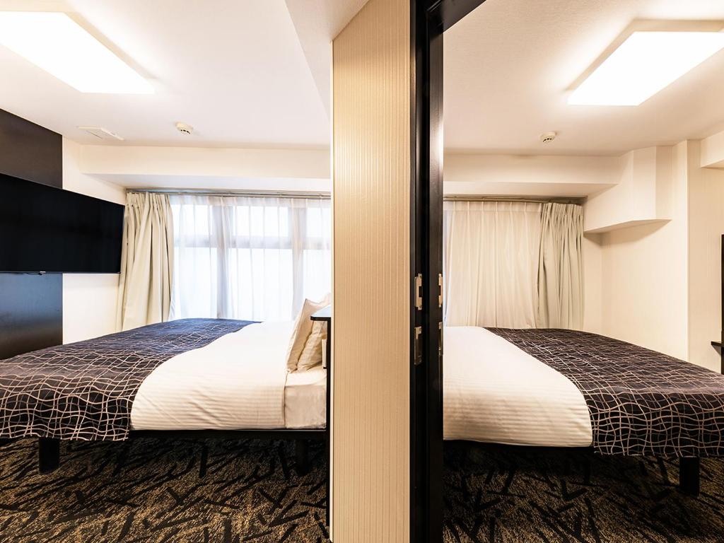 Postel nebo postele na pokoji v ubytování APA Hotel Nambaminami Daikokucho Ekimae