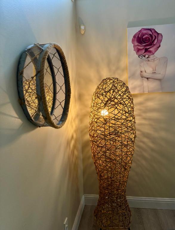 a vase and a mirror on a wall at Gorgeous House&30 second Bus station Close C-Train& Free Parking in Calgary
