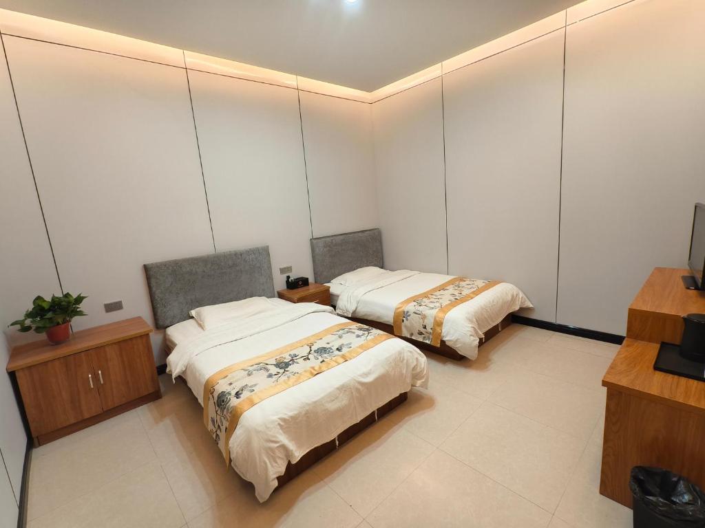 Postel nebo postele na pokoji v ubytování Huashan Gehui Hotel