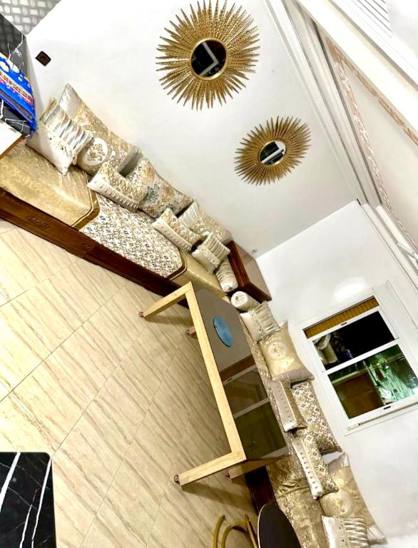 a living room with two mirrors on the ceiling at Nador cornich calme in Nador
