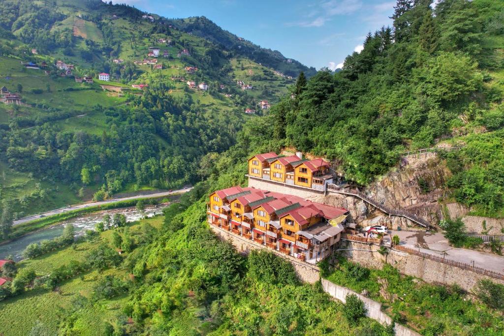 an aerial view of a house on the side of a mountain at panoramabungalov in Çamlıhemşin