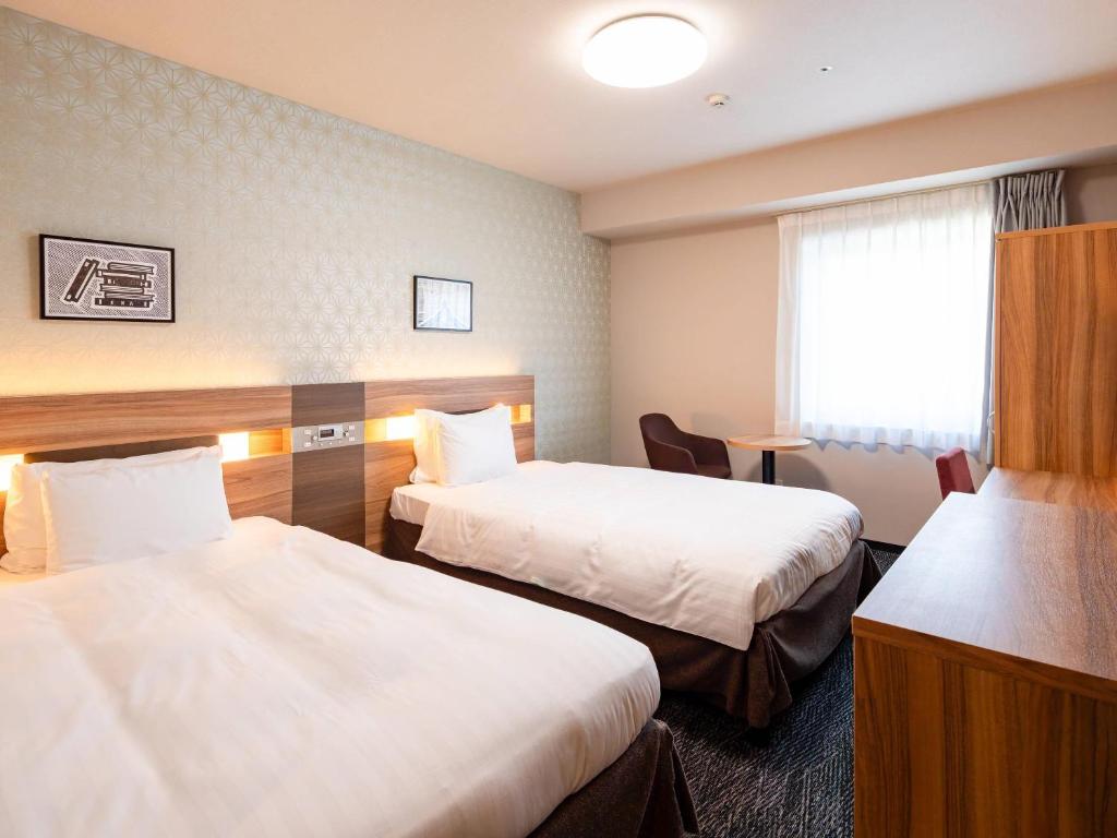 Postel nebo postele na pokoji v ubytování Comfort Hotel ERA Tokyo Higashi Kanda
