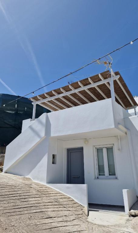 a white house with a staircase leading up to it at Angel's Petit House in Triovasálos