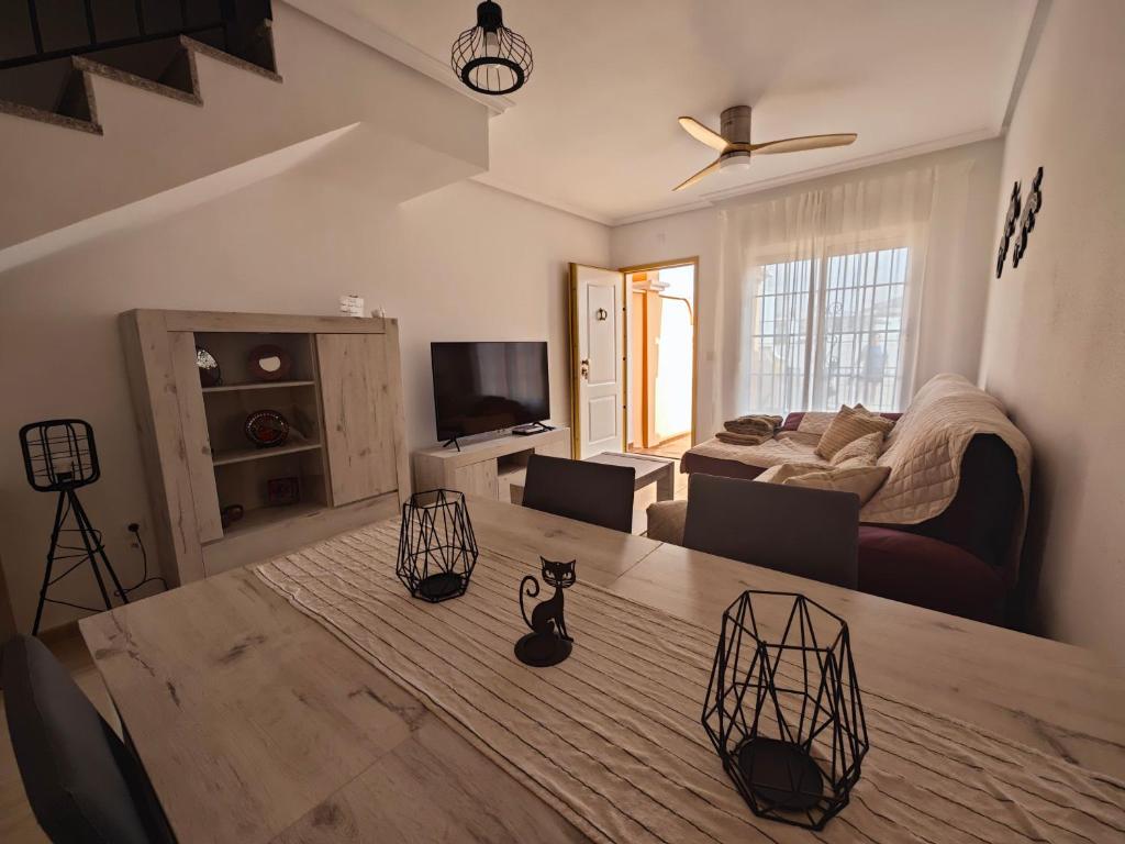 a living room with a table and a couch at Villa Terreros 67 in San Juan de los Terreros