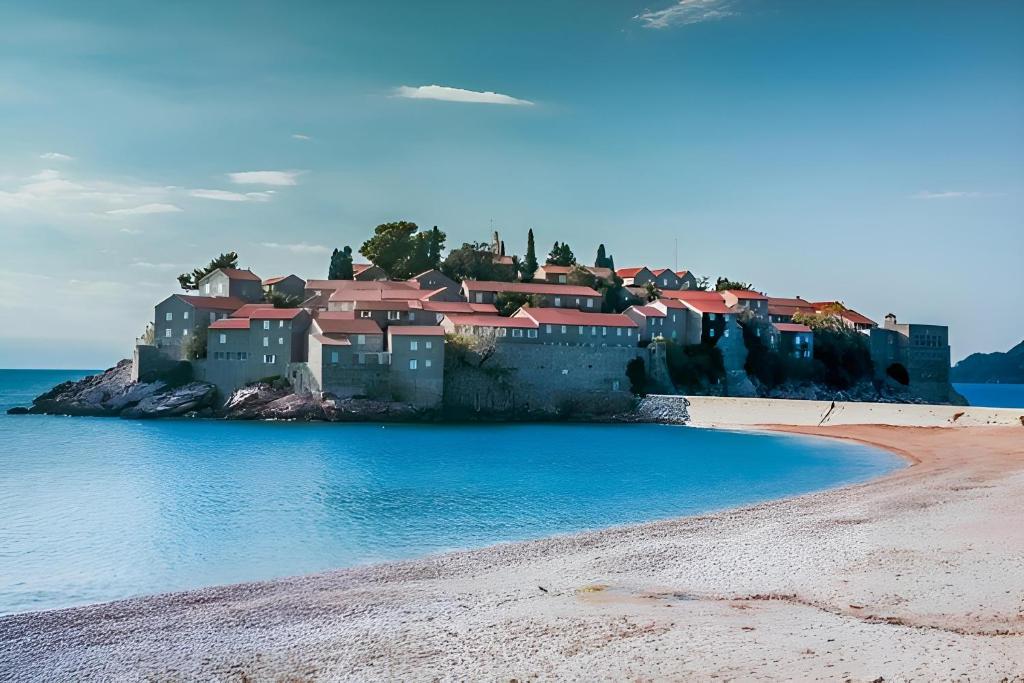 a house on a island in the water at Apartment Ruzica in Sveti Stefan