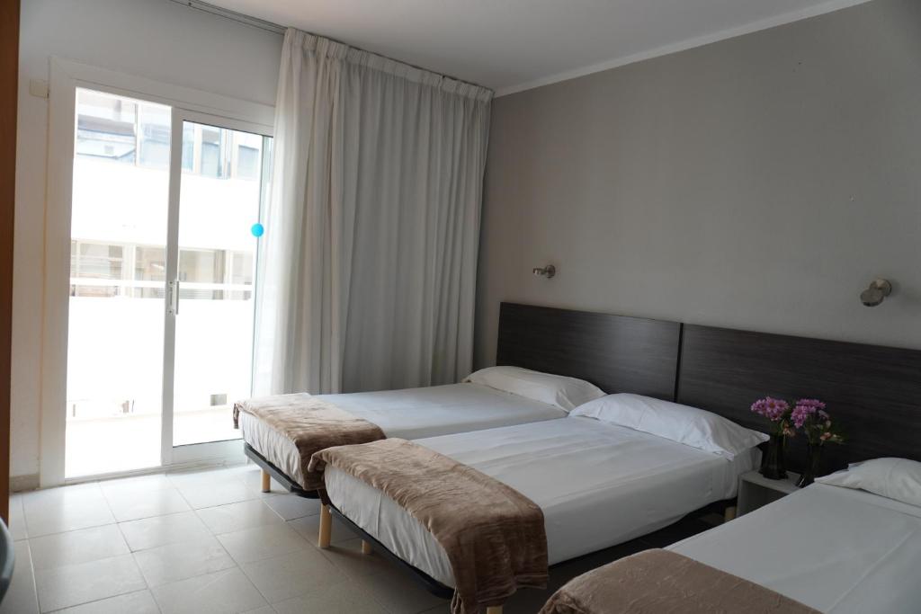 Postel nebo postele na pokoji v ubytování Hotel Ram Rooms Tahiti