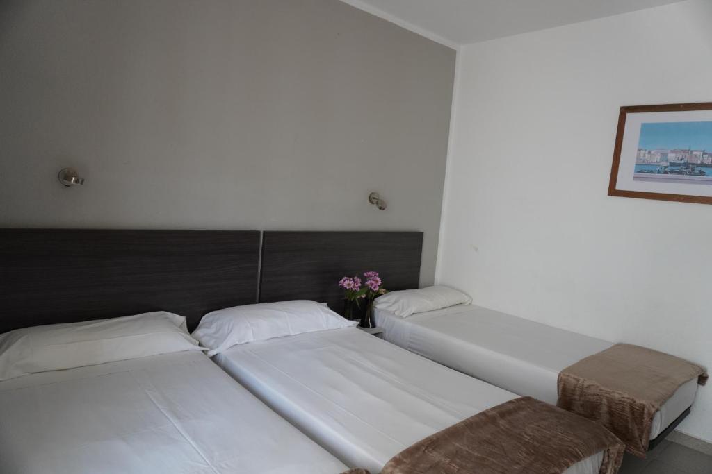 Postel nebo postele na pokoji v ubytování Hotel Ram Rooms Tahiti