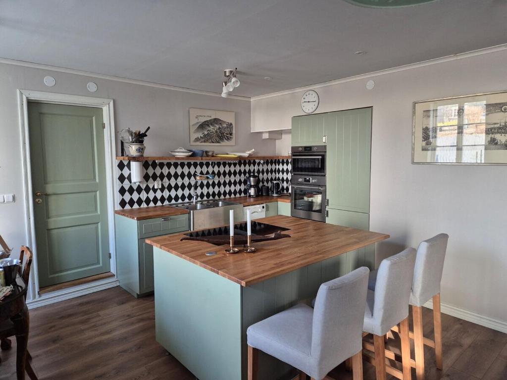a kitchen with a island with a wooden counter top at Apartment in central Öregrund in Öregrund