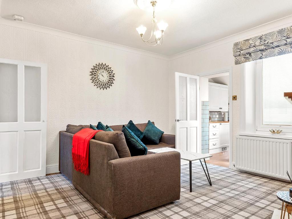 a living room with a couch and a table at Workington Haven - 3 Bed Home in Workington