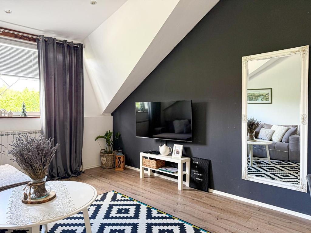 Televízia a/alebo spoločenská miestnosť v ubytovaní Elysian Apartments