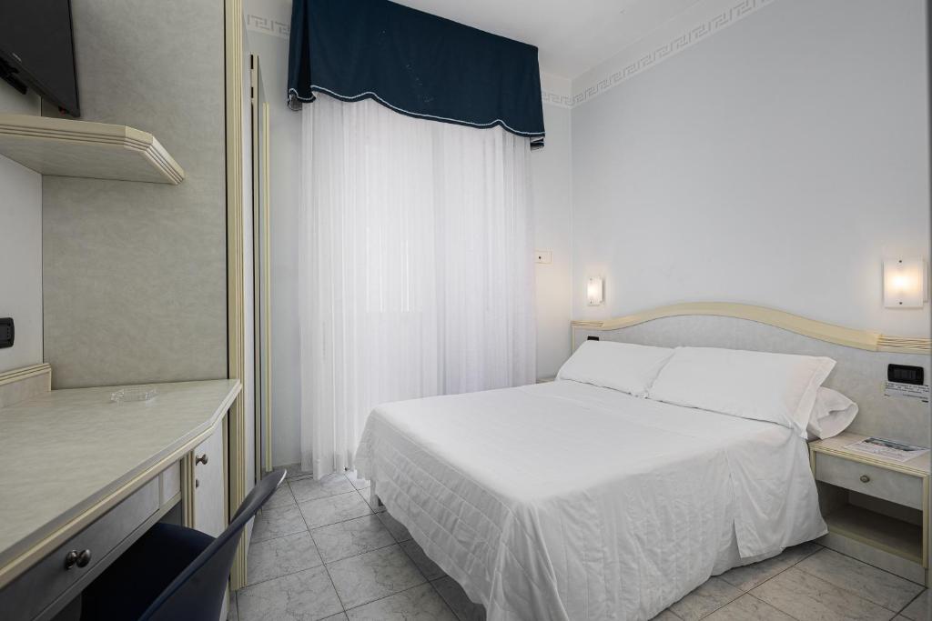 Postel nebo postele na pokoji v ubytování Hotel Oriente