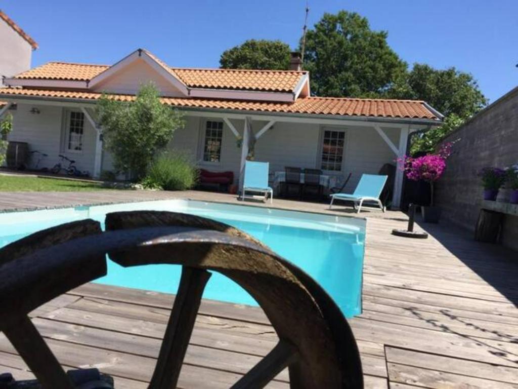 une maison avec une piscine devant une maison dans l'établissement Location pour 4 personnes avec piscine, à Pessac