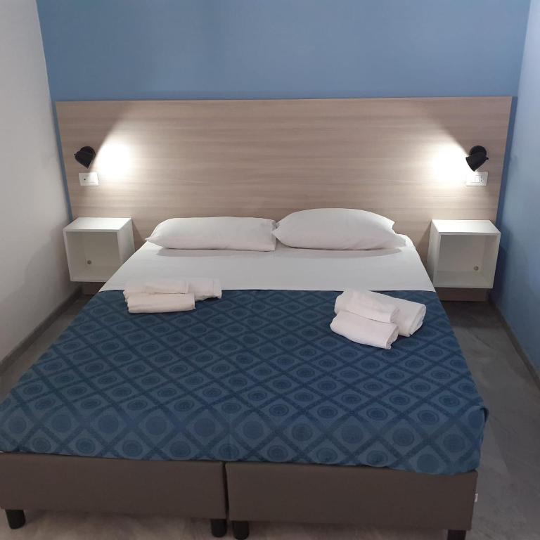 a bedroom with a bed with two towels on it at Funny Village Dog Friendly in Pizzo