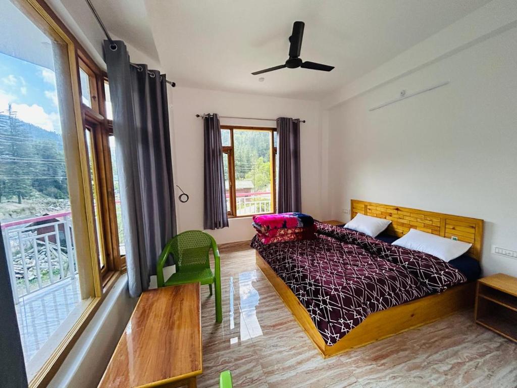 a bedroom with a bed and a large window at Barot Palace in Barot 