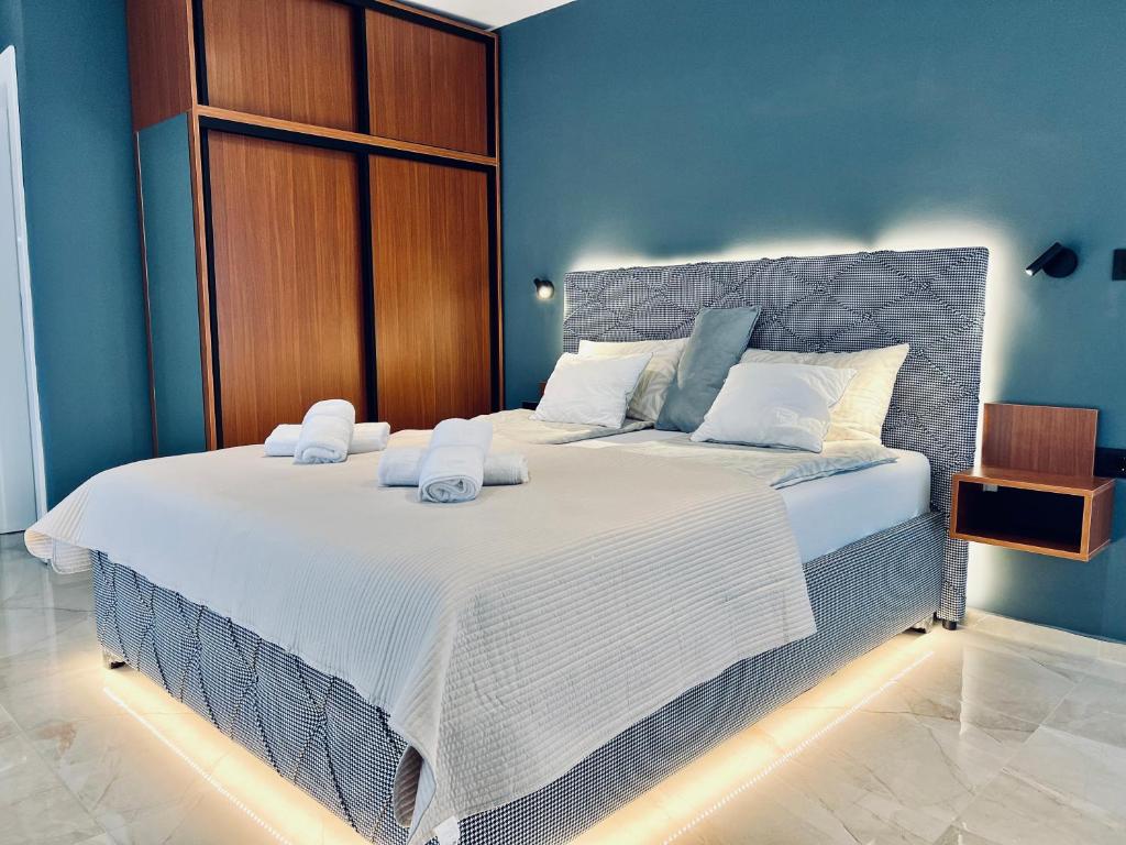 a bedroom with a large bed with towels on it at Lucid Apartment 1 in Crvenka
