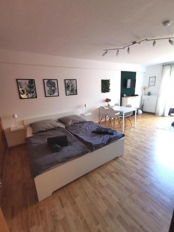 a bedroom with a bed and a table in a room at Apartment Kleine Auszeit Kadenbach in Kadenbach