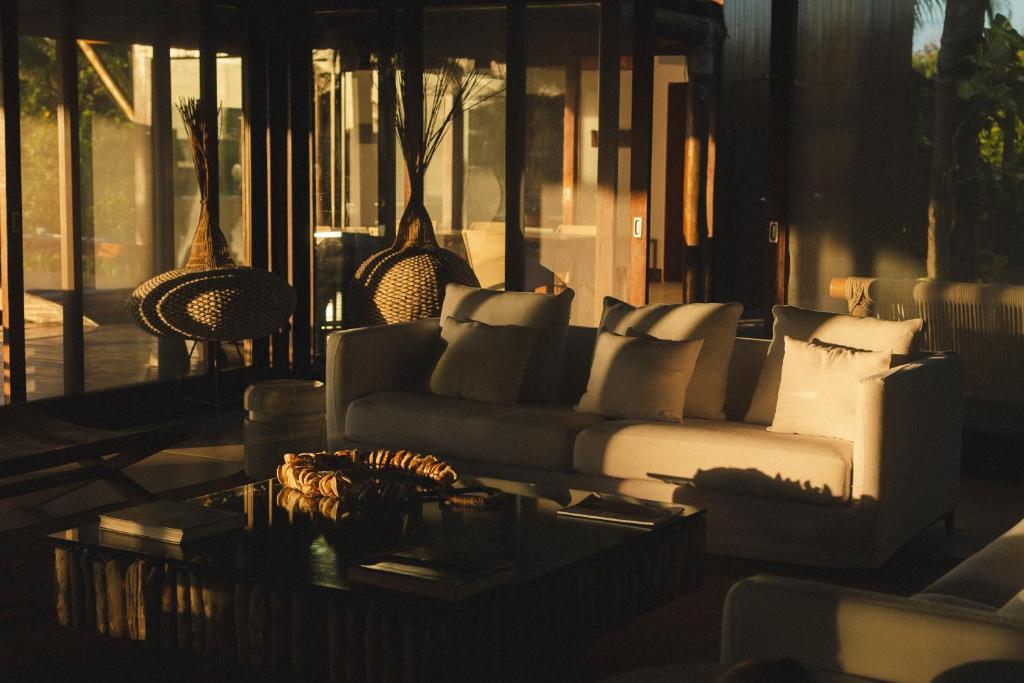 a living room with a couch and a table at Pousada Maravilha in Fernando de Noronha