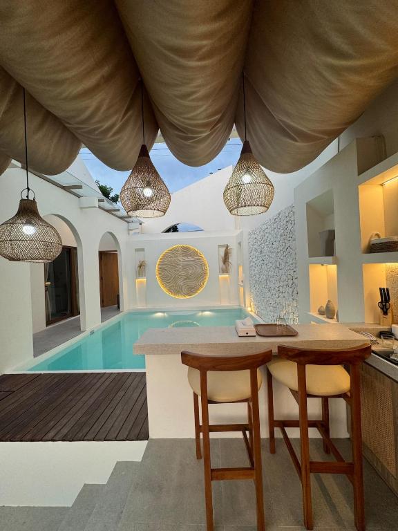 a kitchen and dining room with a swimming pool at Fulton Villa Alexandria 2BR in Sleman