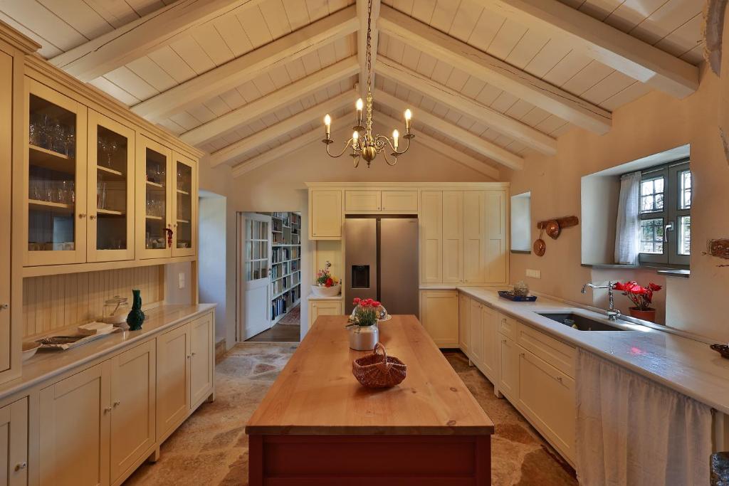 a large kitchen with a table and a chandelier at KATIKIA ZAGORI in Vitsa
