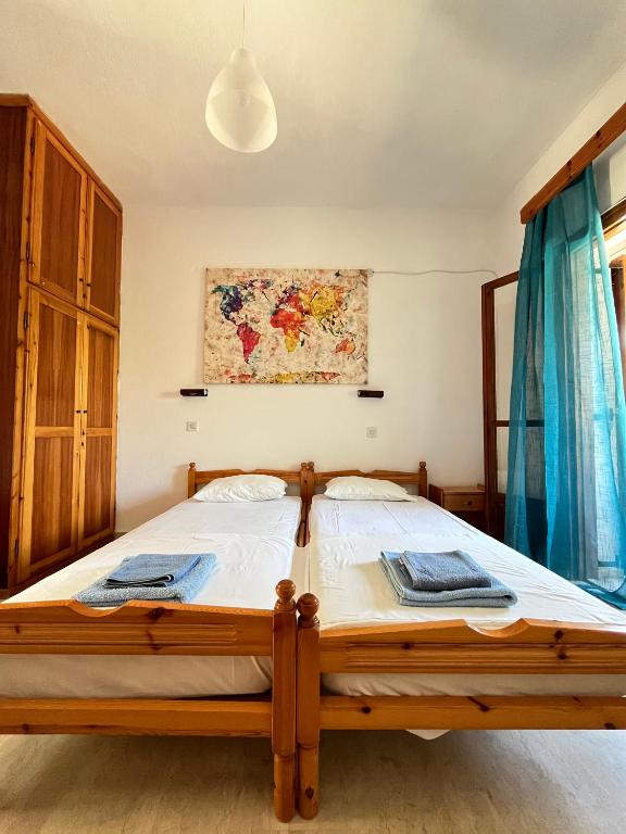 a bedroom with a wooden bed in a room at Studio Pavlos in Dassia
