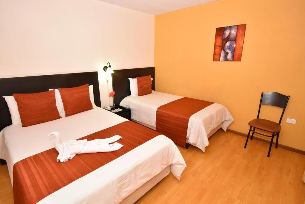 Postel nebo postele na pokoji v ubytování Hotel Montecarlo