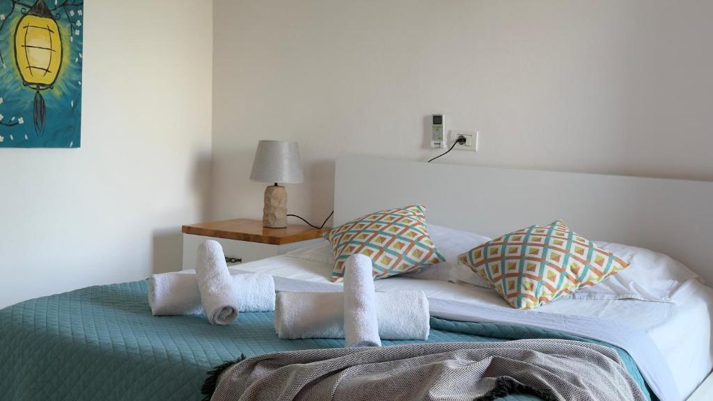a bedroom with a bed with towels on it at Rida Village Ksamil Island in Ksamil