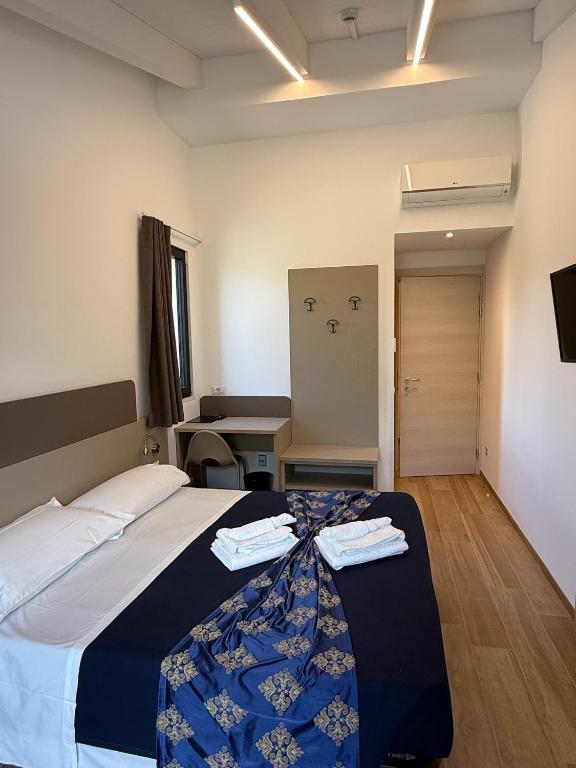 Postel nebo postele na pokoji v ubytování Hotel Merloni
