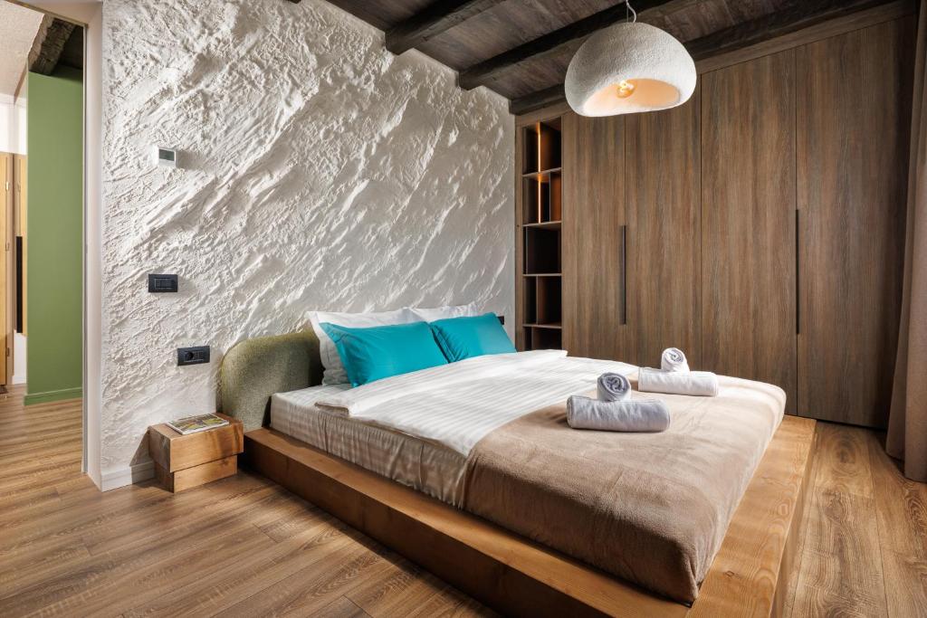 a bedroom with a large bed with blue pillows at Mountain View Chalet - Poiana Brasov in Braşov