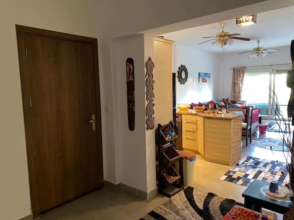 a living room with a kitchen and a living room with at Amwaj ground apartment in El Alamein