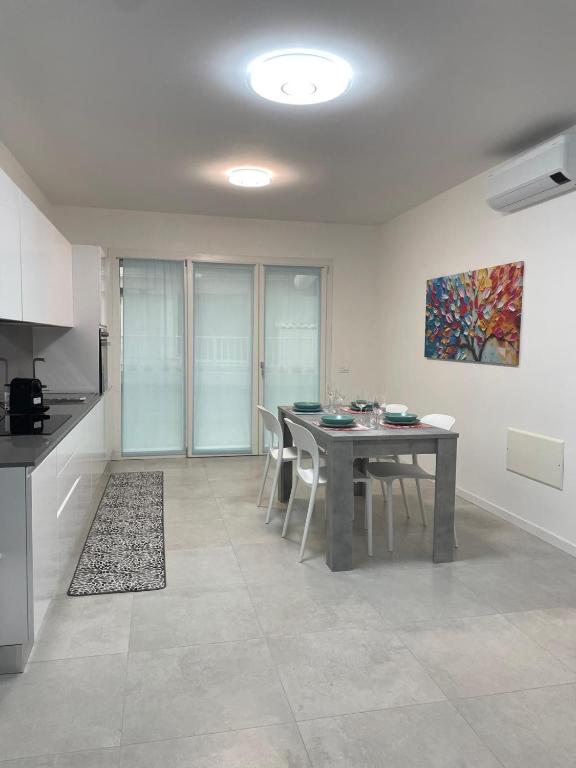 a kitchen and dining room with a table and chairs at Marina Garden in Cattolica