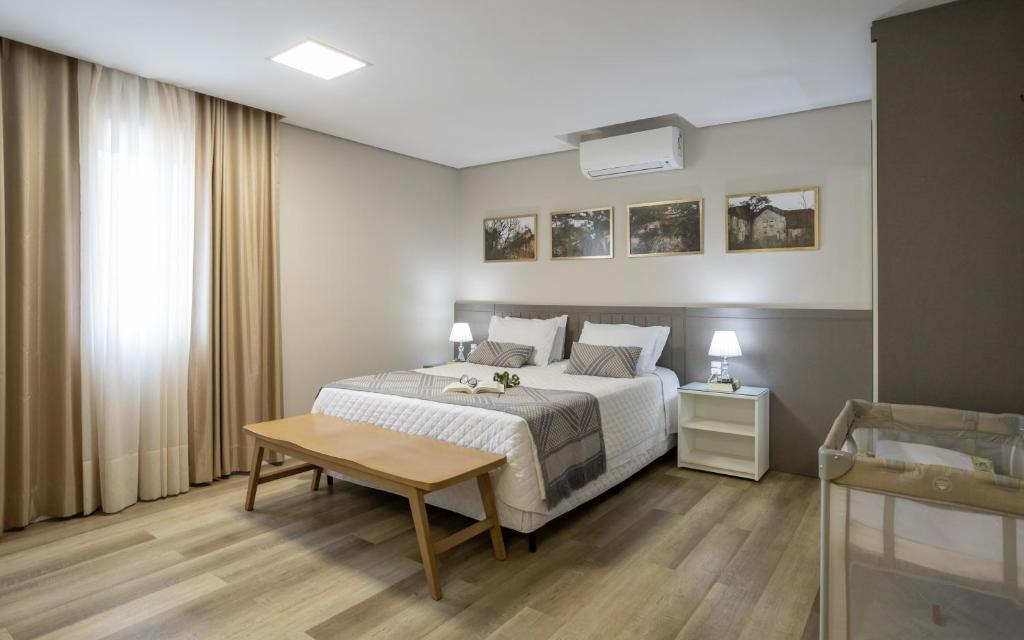 Postel nebo postele na pokoji v ubytování Villary Flats Gramado