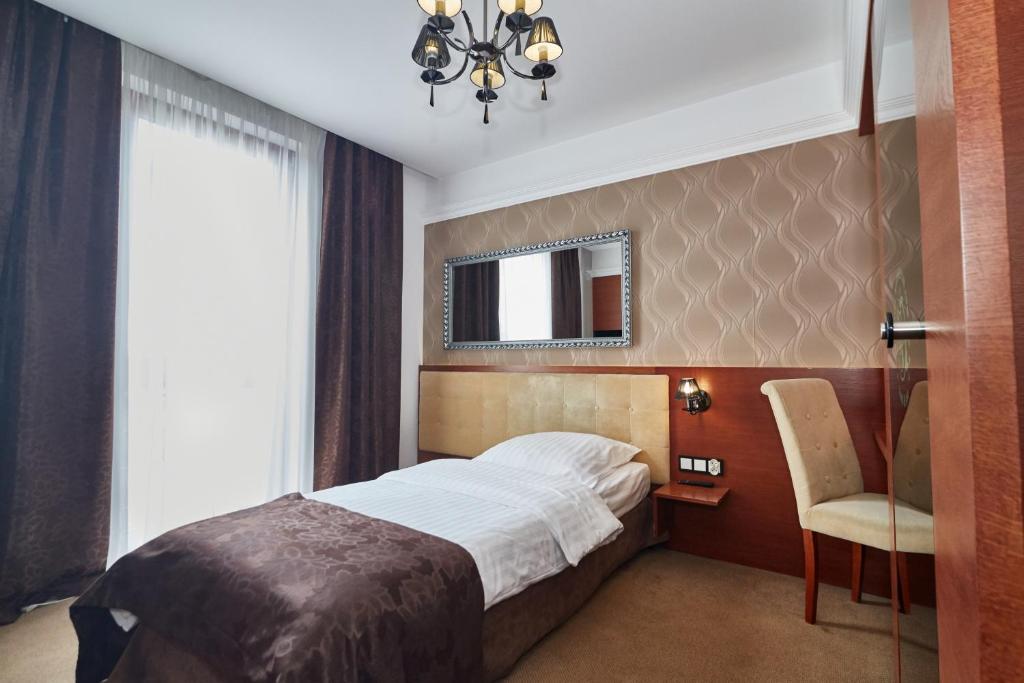 Postel nebo postele na pokoji v ubytování Hotel&Spa Kameleon