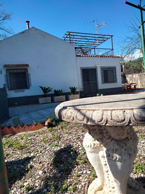 a stone bench sitting in front of a house at Etna view Villa Letizia a Taormina in Taormina