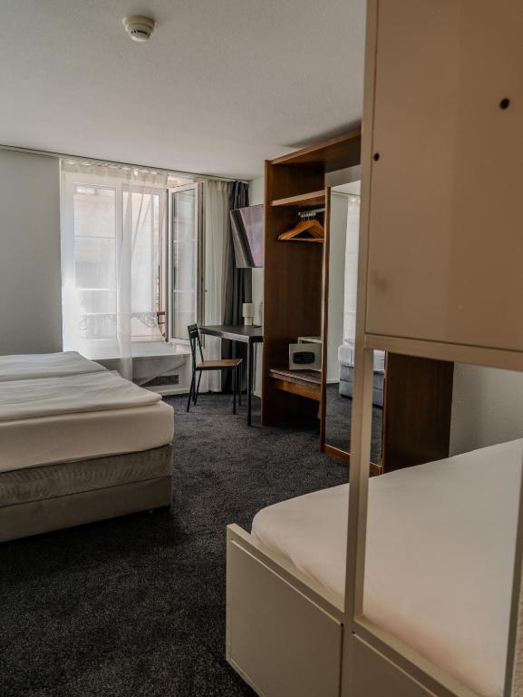 Postel nebo postele na pokoji v ubytování Hotel Baslertor