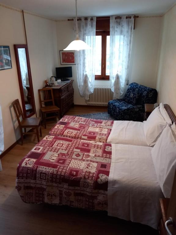Postel nebo postele na pokoji v ubytování Pensione Genzianella