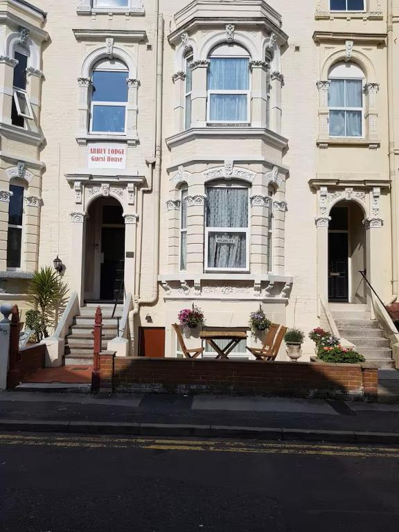 a white building with a table in front of it at Abbey Lodge Guest House in Bournemouth
