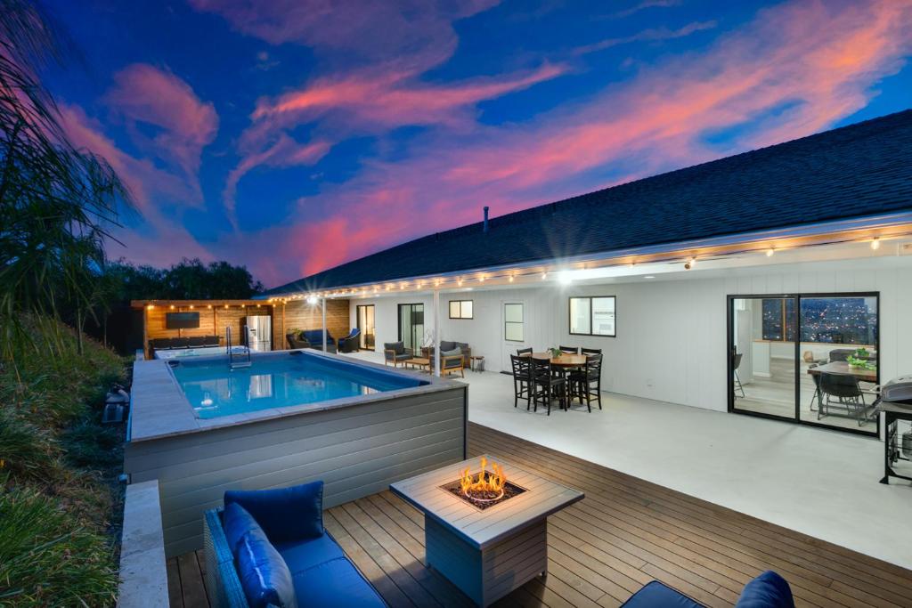 a backyard with a swimming pool and a house at Sleeps 31 10br Mountain View, Pool, Spa and Games in El Cajon