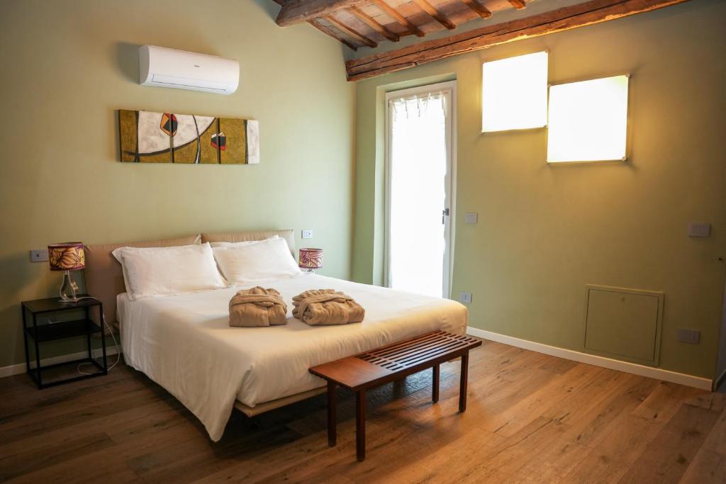 a bedroom with a bed with two pillows on it at LЄ STΛNZЄ di KΛMΛ' in Cesena