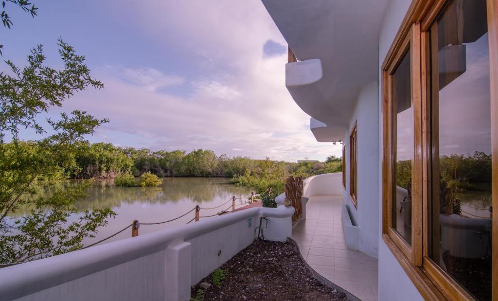 a balcony with a view of a river at Lava Heron Galapagos Apartment in Puerto Ayora