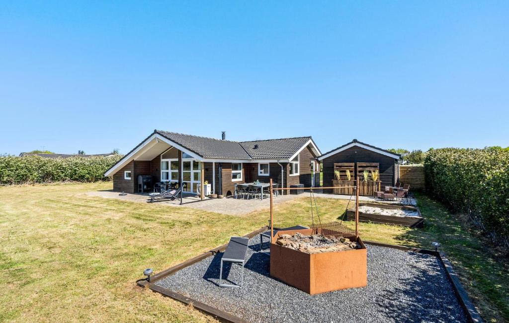 a house with a large yard with a house at Holiday Home Sivsangervænget Tarm in Hemmet