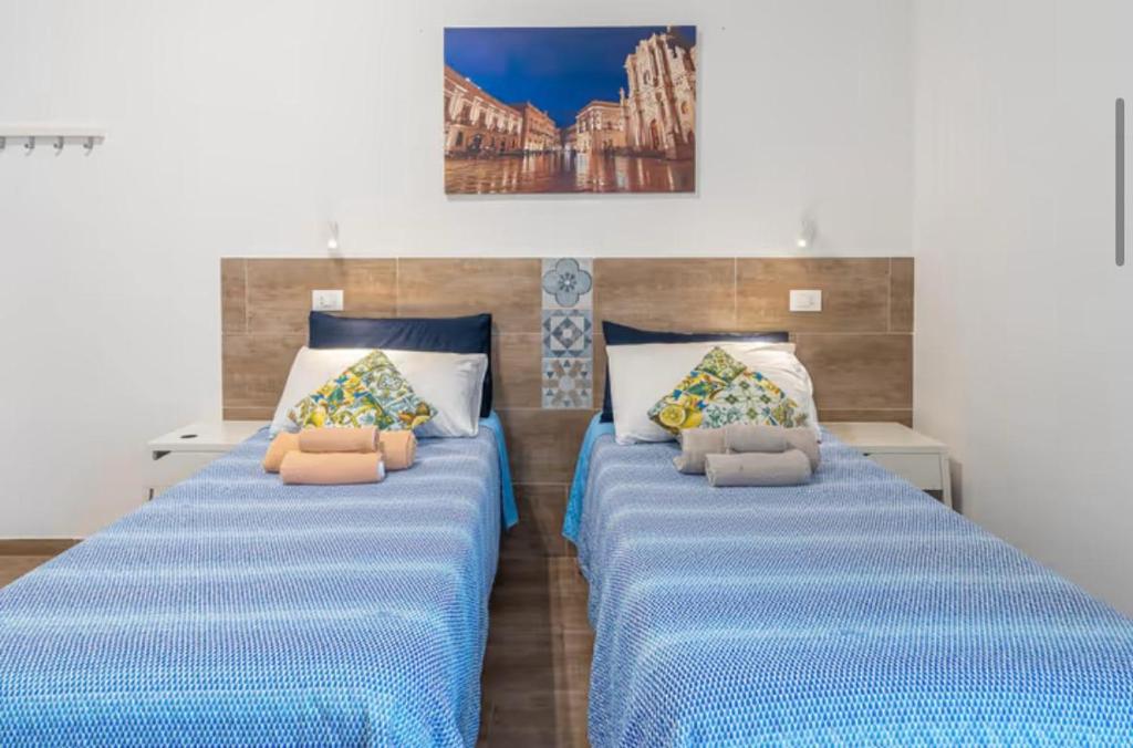 Postel nebo postele na pokoji v ubytování RAUDINO ROOMS