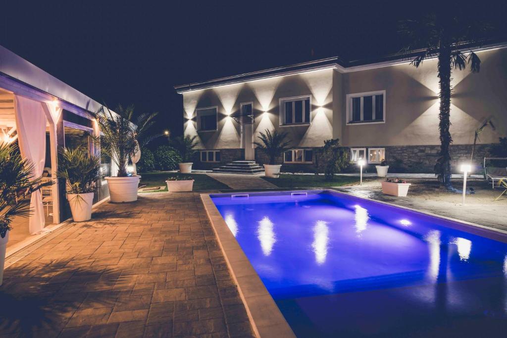 a swimming pool in front of a house at night at Villa Marchese Lake Maggiore in Somma Lombardo