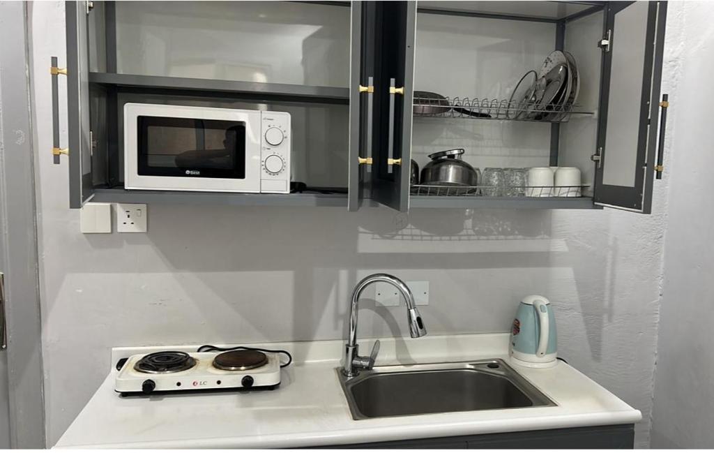 a kitchen counter with a sink and a microwave at مسك 3 Musk in Al Madinah