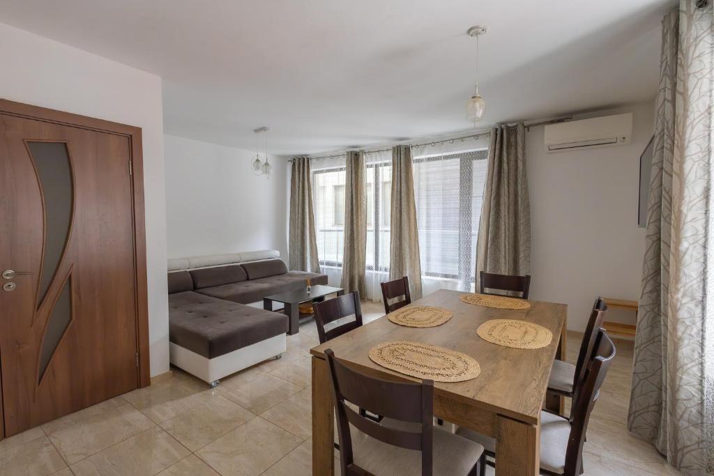 a living room with a dining room table and a couch at Sea Garden Marina 2 in Varna City