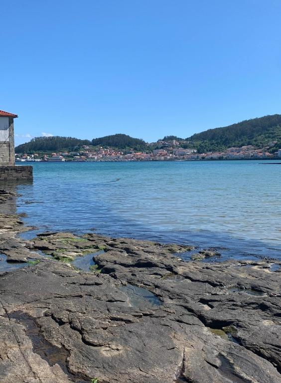 a view of a body of water with rocks at Piso Praia da Rocha in Serres